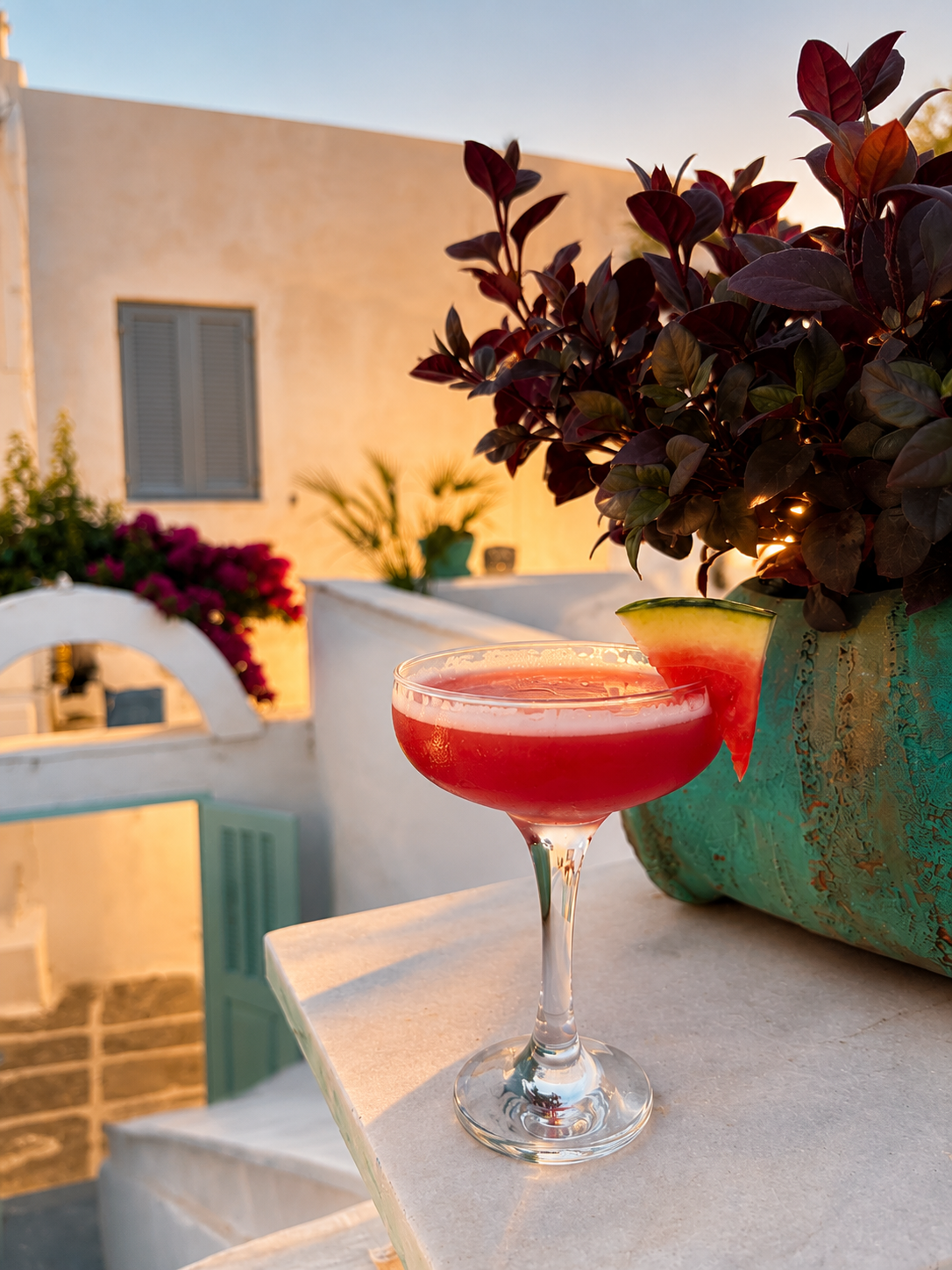 The Aegean Negroni served with a watermelon slice at sunset.