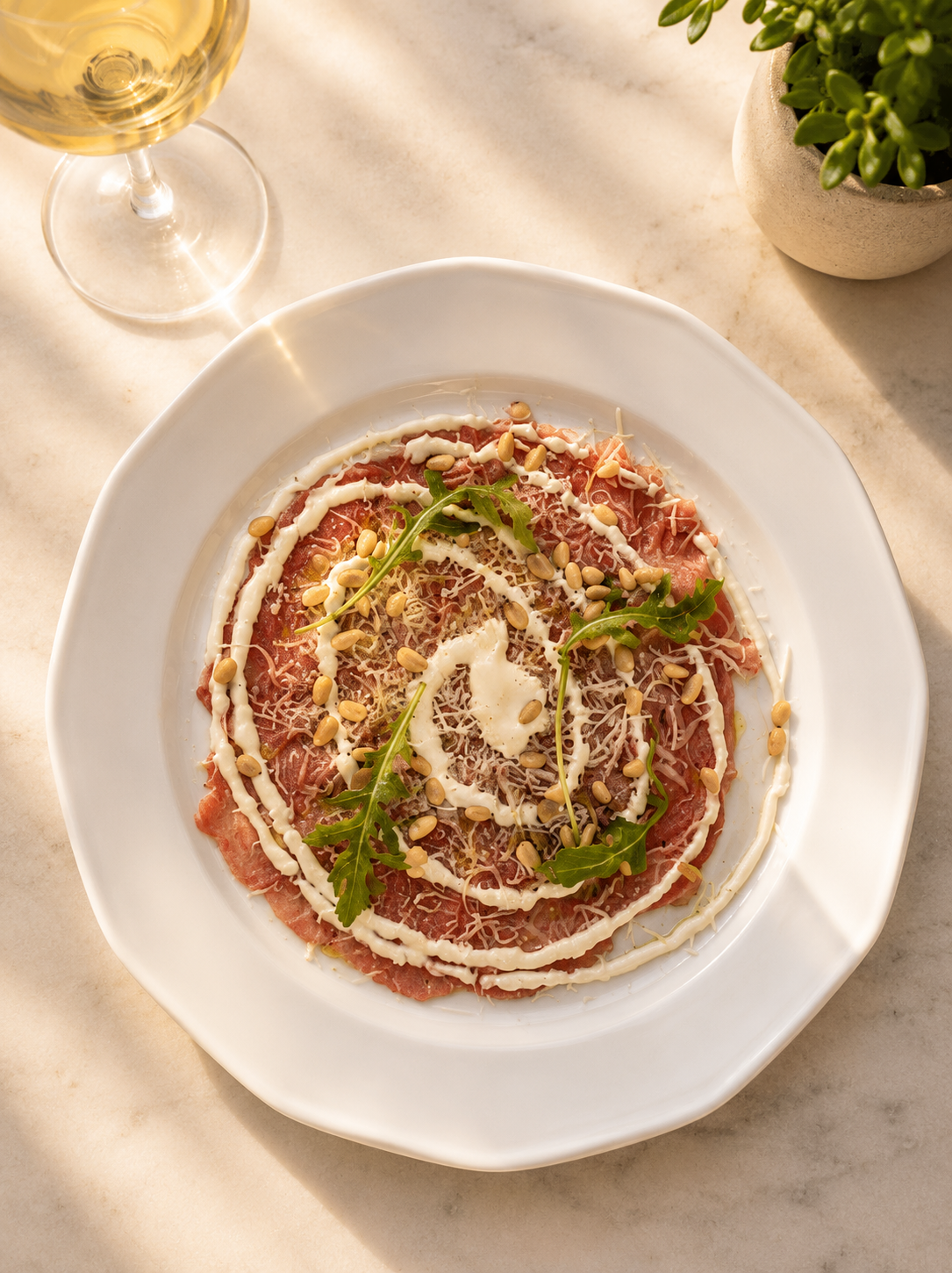 Beef carpaccio with kefalotyri cheese, pine nuts and truffle.