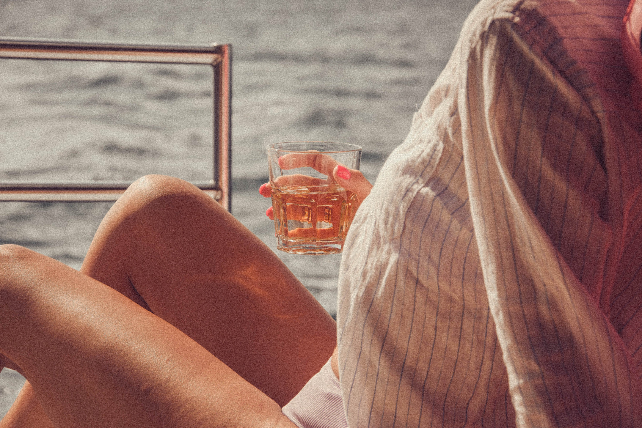 A sunset glass raised over the Aegean.