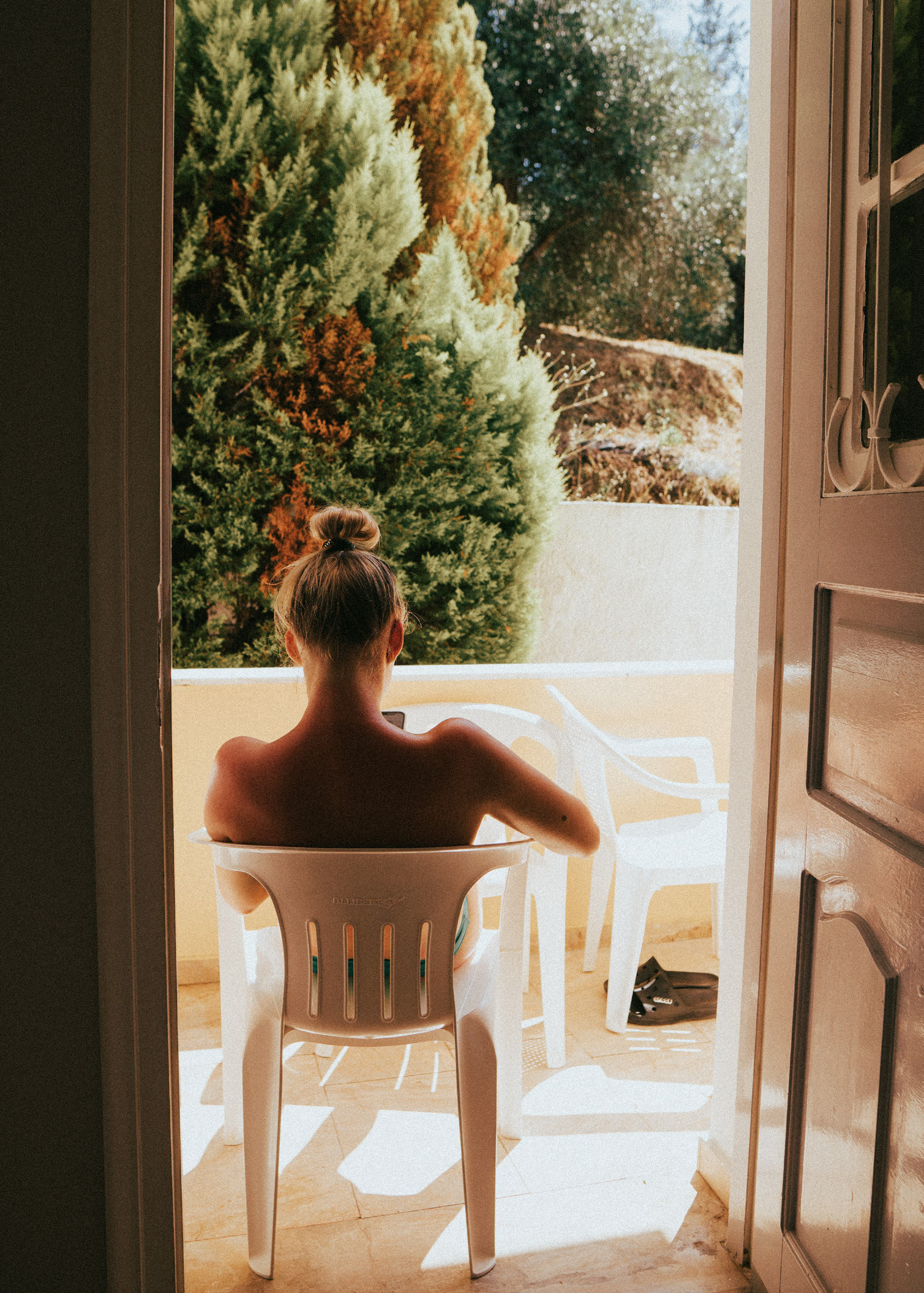 A guest in a sunlit doorway.