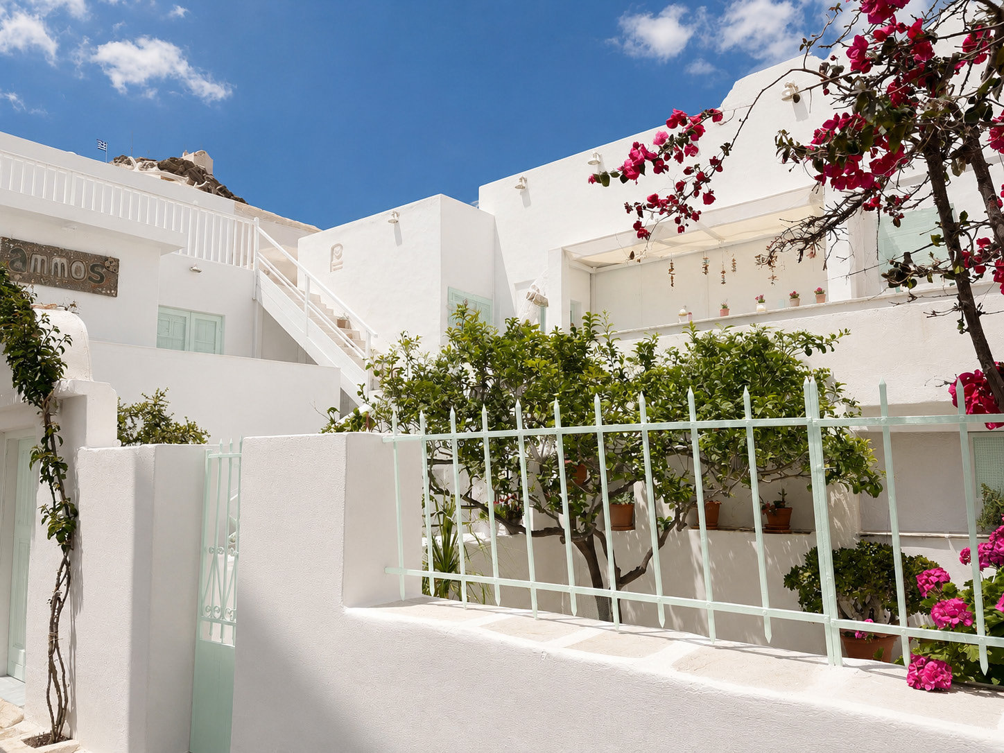 Chora alleyways and bougainvillea against the sky.